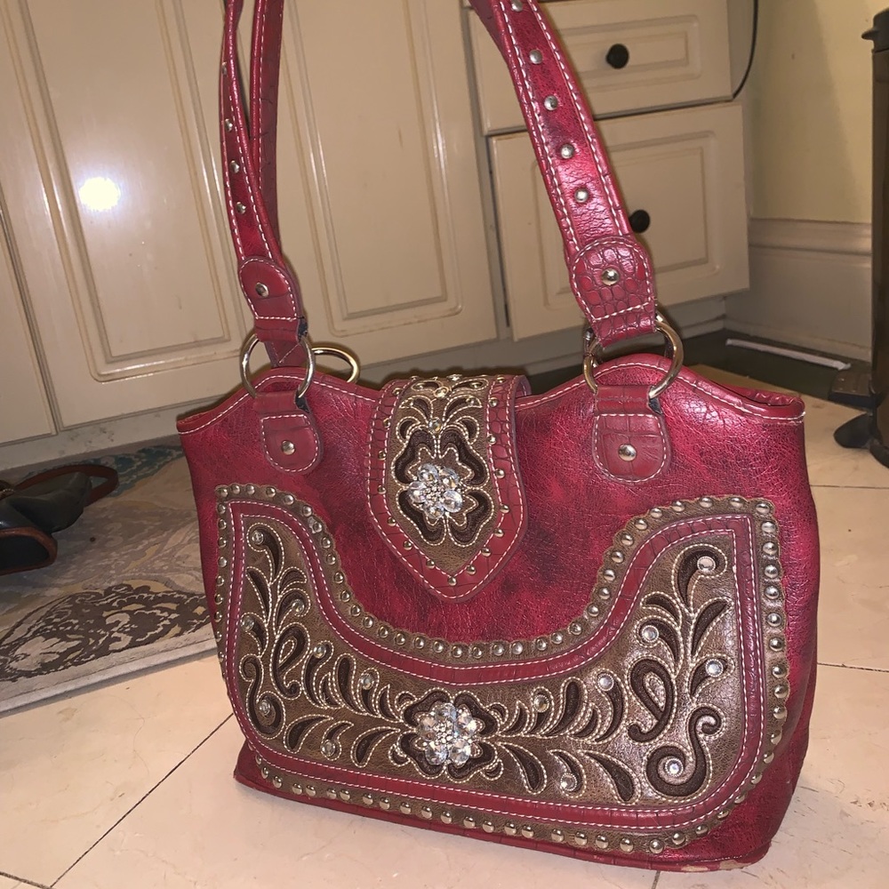 A red crystal studded purse